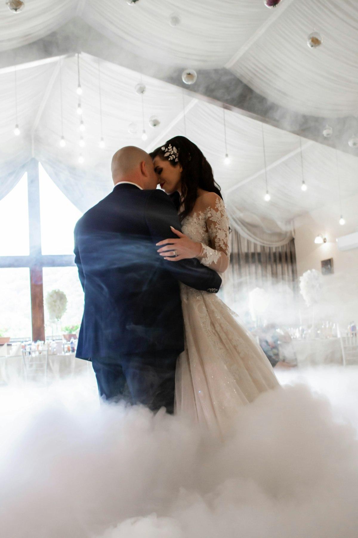 A first dance on a floor covered in low-lying fog